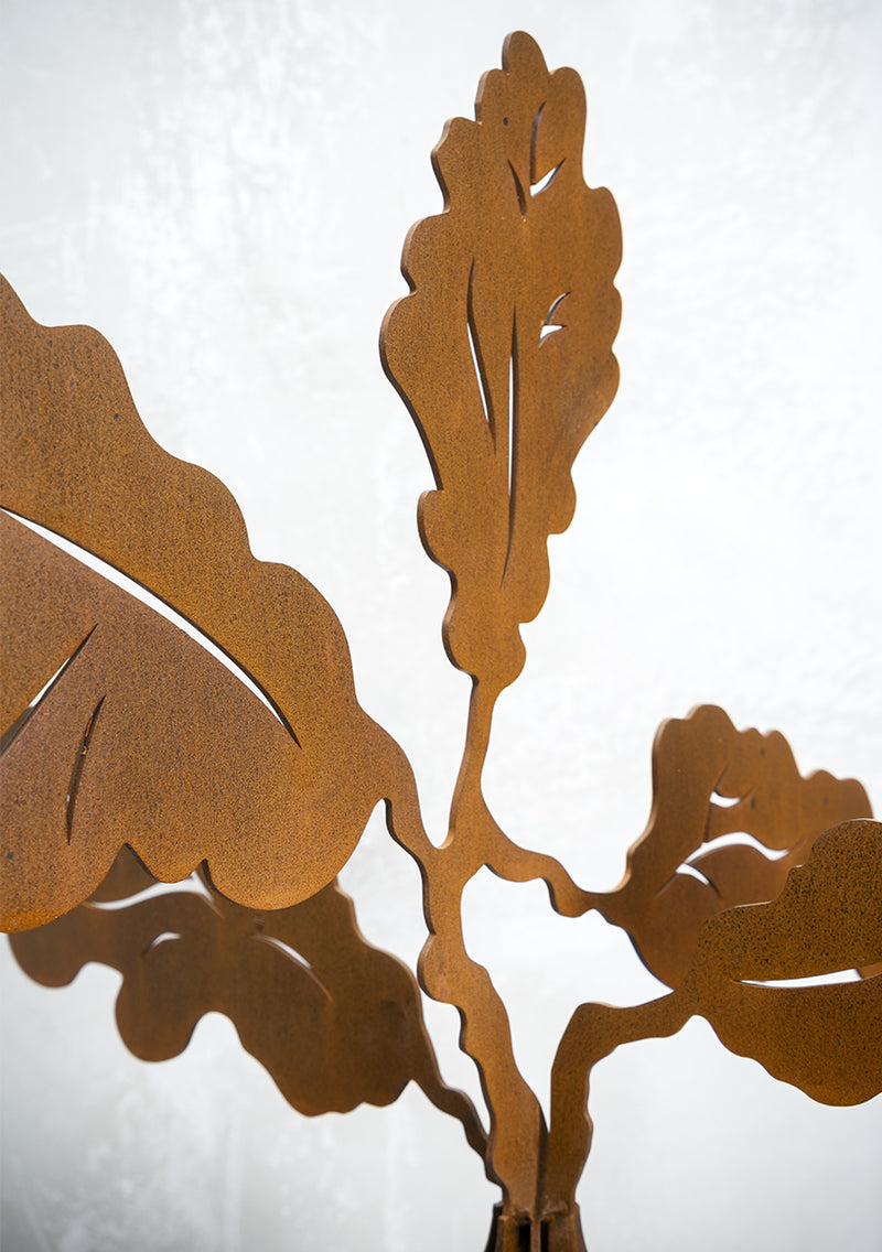 Acorn Outdoor Sculpturelose-up detail of an outdoor sculpture showing 3mm thick layers of Corten metal slotted together with oak leaf details. Brief Description: This image provides a close-up view of an outdoor sculpture made from 3mm thick layers of Corten metal. The layers are intricately slotted together, featuring detailed oak leaf designs. The rust finish and craftsmanship highlight the sculpture's rustic elegance and artistic precision.
