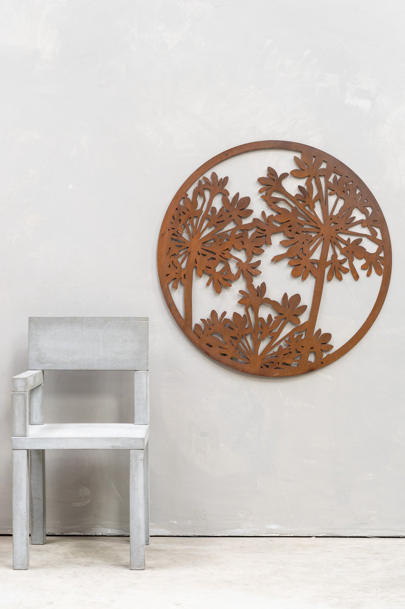 lt Text: Agapanthus wall art in an outdoor setting.  Brief Description: This image shows agapanthus wall art displayed in an outdoor setting. The artwork features detailed depictions of agapanthus flowers, integrated into a natural environment. The setting enhances the beauty of the wall art, blending it seamlessly with the surrounding outdoor elements.